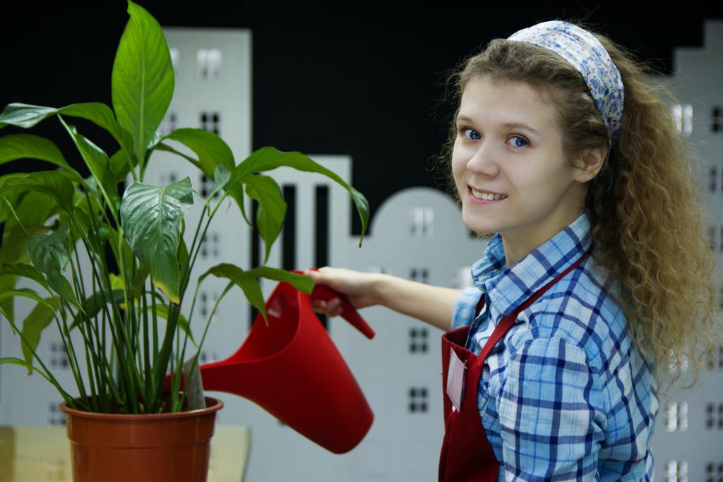 A young teen waters plants at a garden center she volunteers at. Teach teens the value of emotional intelligence in teens with the help of Therapy for Teens in Metairie, LA.