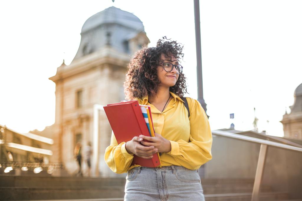 A teen in a yellow jacket deals with her anxiety over getting into an Ivy League School. Therapy for Teens with Anxiety in Metairie, LA can help.